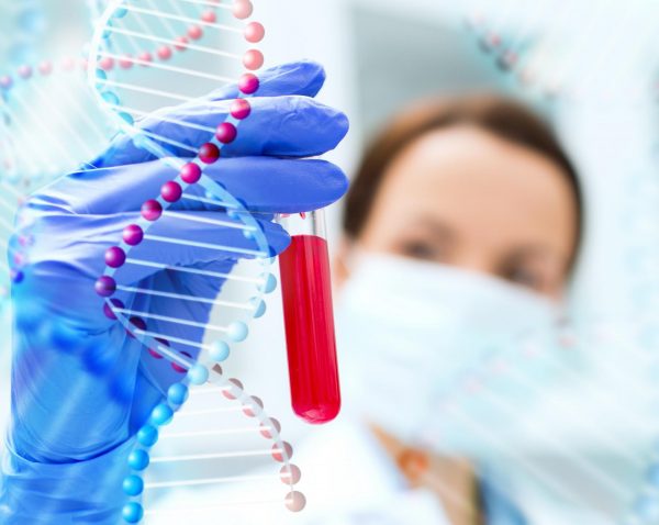 Кровь в пробирке и макет ДНК