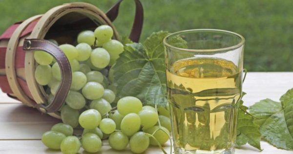 стакан виноградного сока и свежий виноград на столе